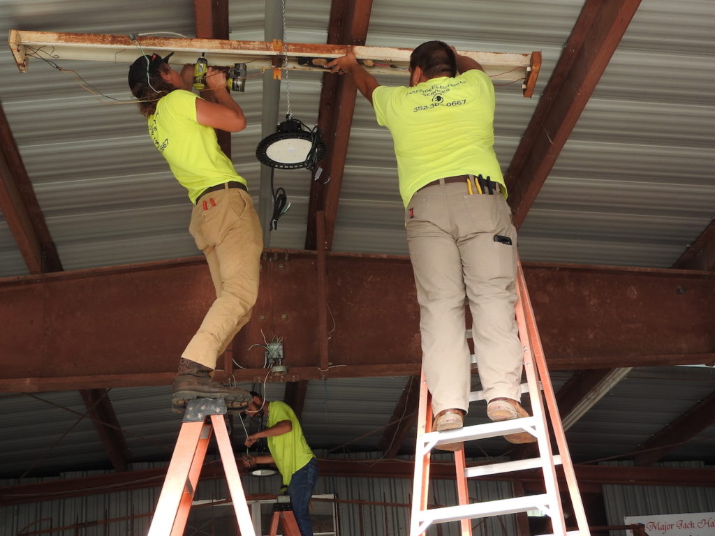 These electricians seemed right at home on these tall ladders.