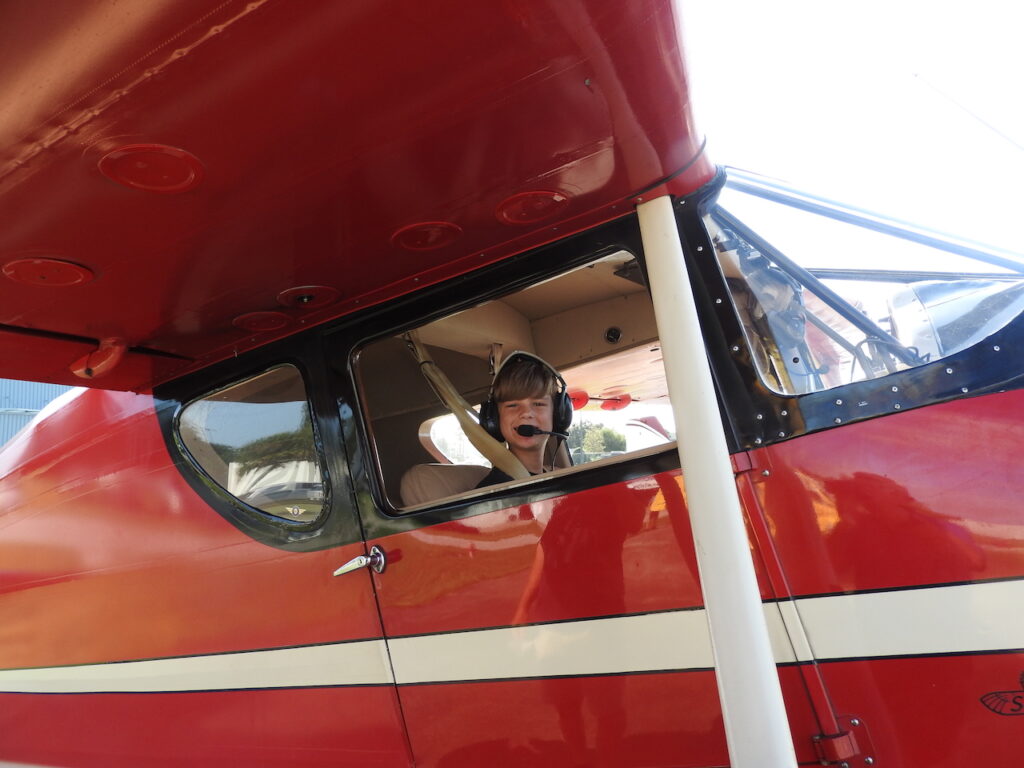 Young Eagle Daniel Swartz is getting a ride in Mark Peebles’ vintage Fairchild aircraft.