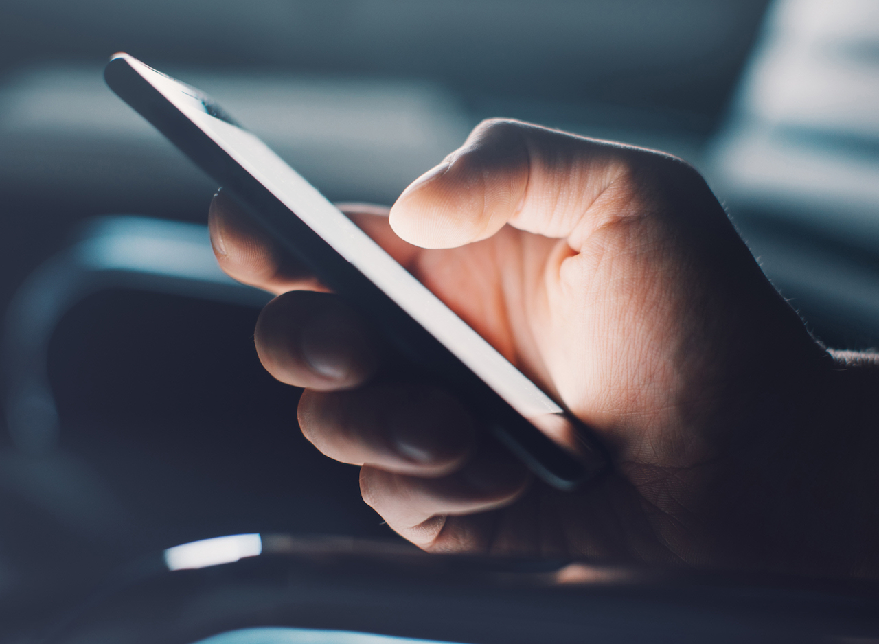 Closeup of man s hand using smartphone