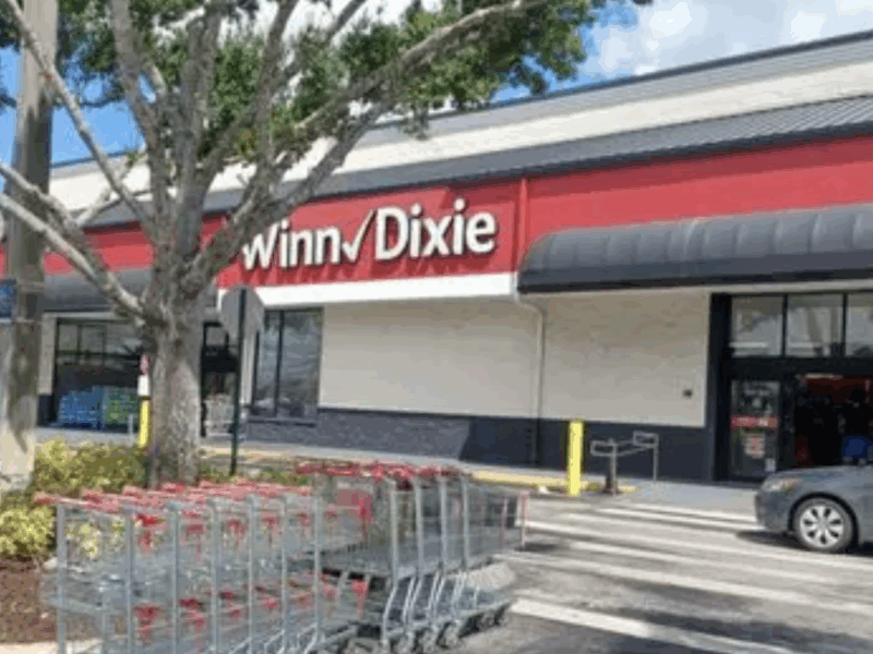 Bartender passes out behind the wheel, double parked with the door open at Winn-Dixie